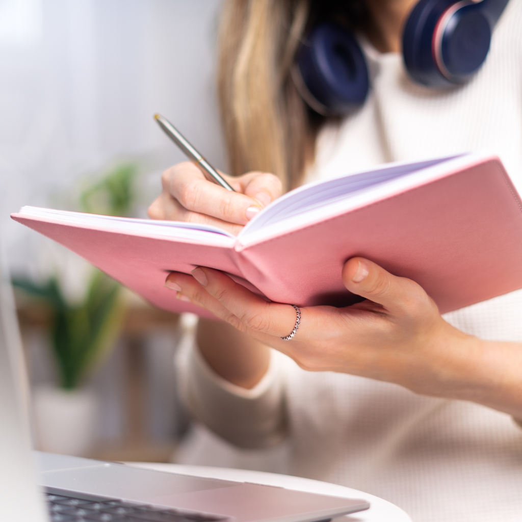 woman writing in notebook